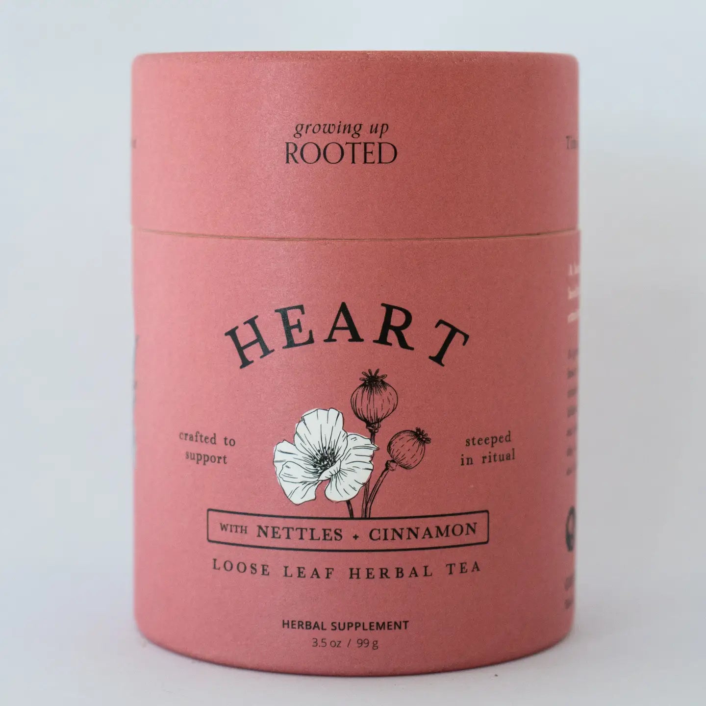Pink container of 'Heart' herbal tea with botanical illustration on a white background